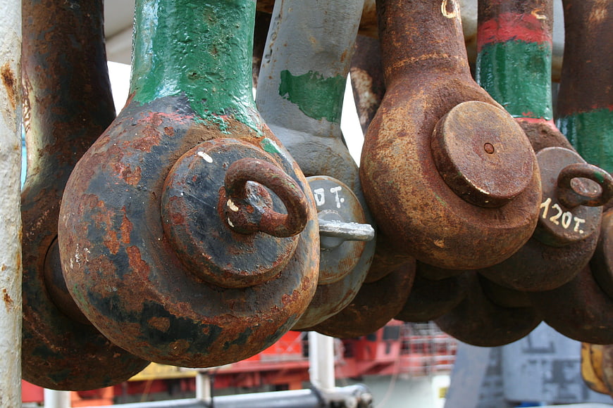 Close-up of rusty industrial crane hooks and heavy machinery parts