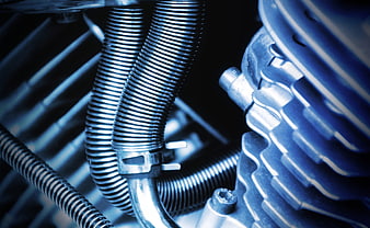 Close-up of motorcycle engine cooling fins and hoses