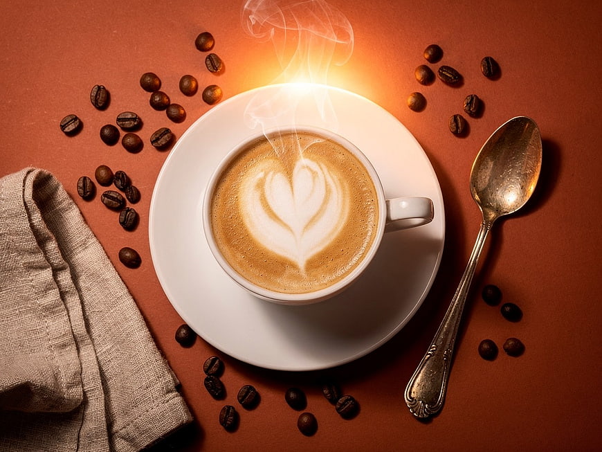 Top View Steaming Latte with Heart Art and Coffee Beans