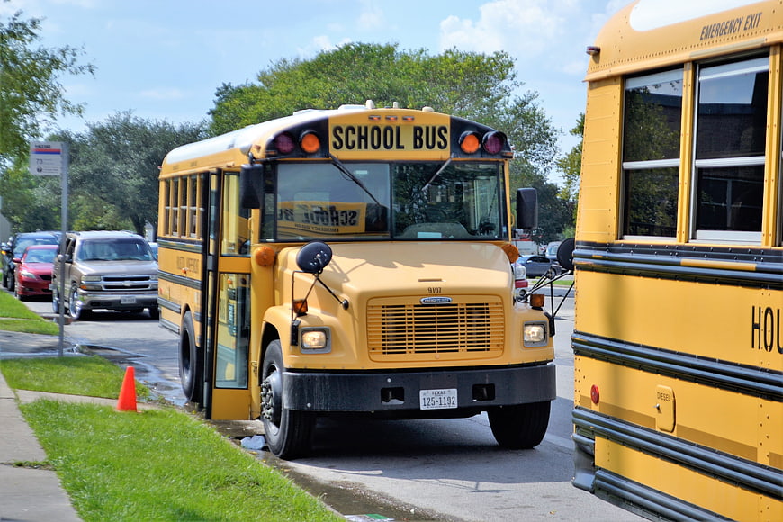 Yellow School Bus Driving on Suburban Street
