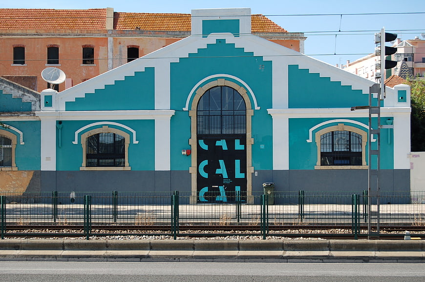 Turquoise and white building facade with arched windows