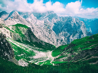 Majestic Alpine Mountain Landscape with Green Valleys and Clouds