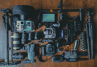 Flat lay of professional video and photography equipment on wood