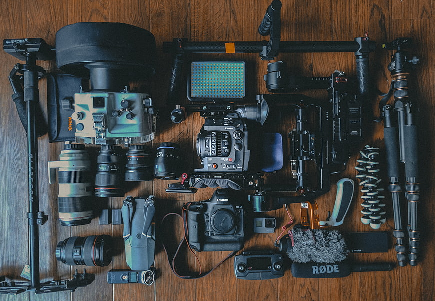 Flat lay of professional video and photography equipment on wood
