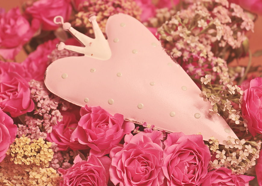 Pink Heart-Shaped Clutch with Crown on Bed of Pink Roses