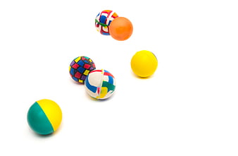 Colorful rubber balls bouncing on white background
