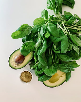 Fresh Avocado, Basil, and Spices on White Background