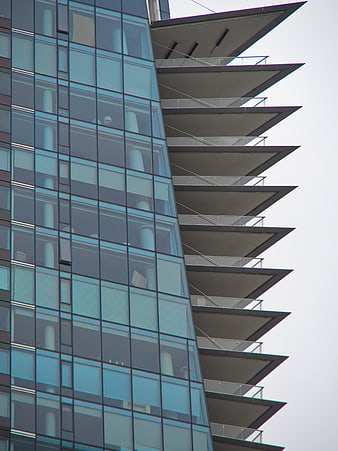 Modern Glass Building Facade with Geometric Balconies