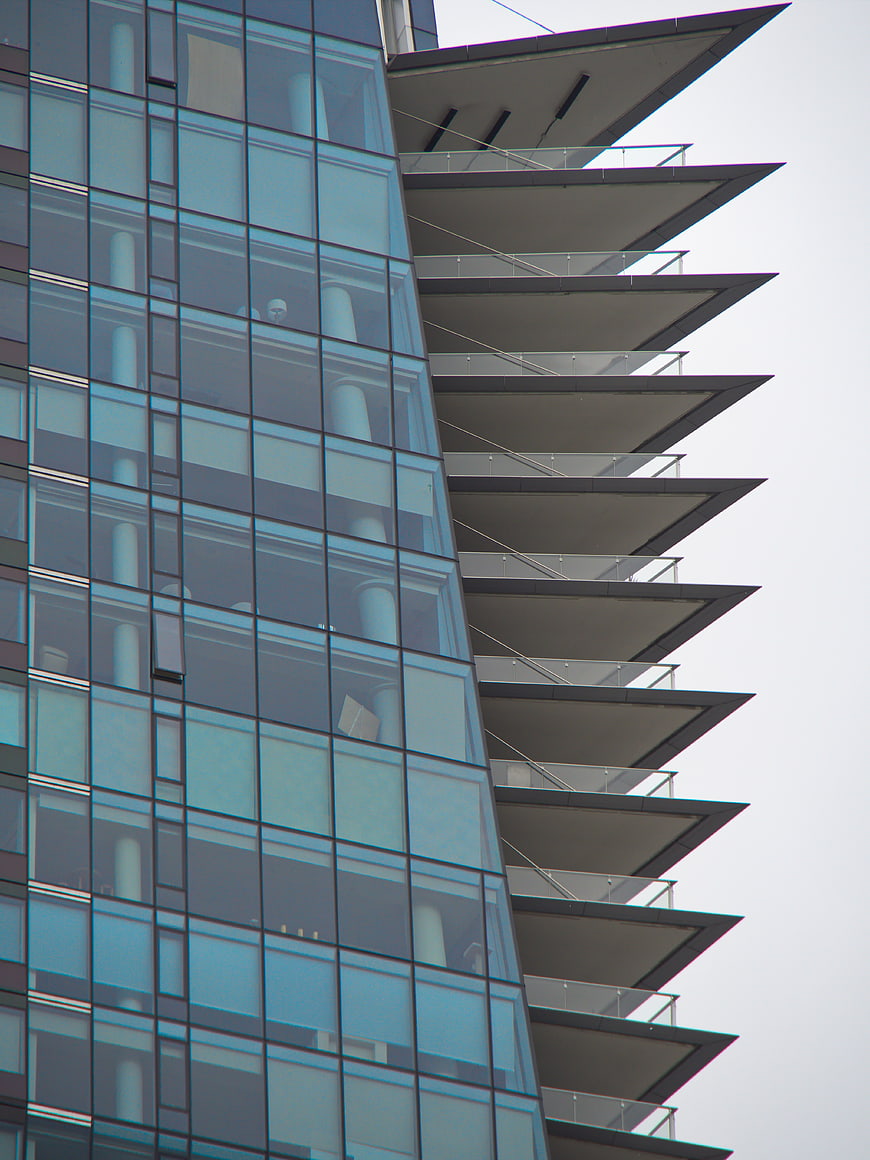 Modern Glass Building Facade with Geometric Balconies