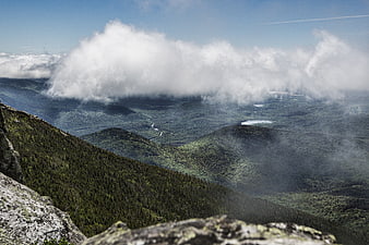 Majestic Mountain Landscape with Clouds and Forested Valley