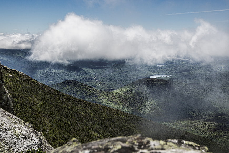 Majestic Mountain Landscape with Clouds and Forested Valley