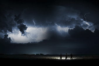Three Silhouetted Figures Watching Lightning Storm at Night