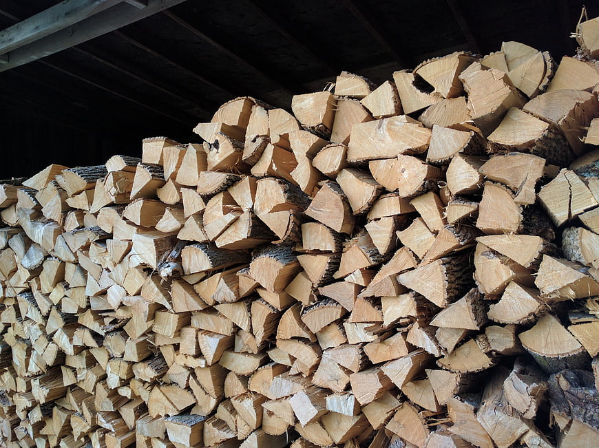 Stack of chopped firewood logs in a shed