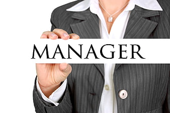 Businesswoman holding manager sign in pinstripe suit