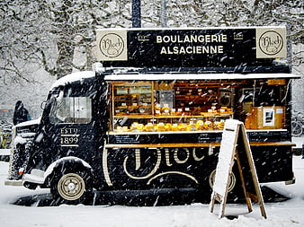 Vintage Black Bakery Food Truck in Snowy Winter