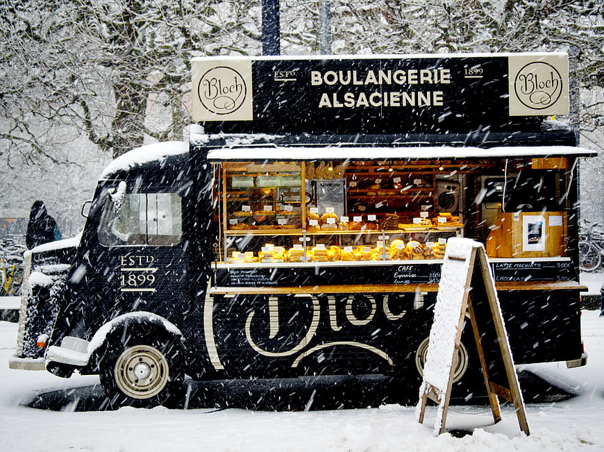 Vintage Black Bakery Food Truck in Snowy Winter
