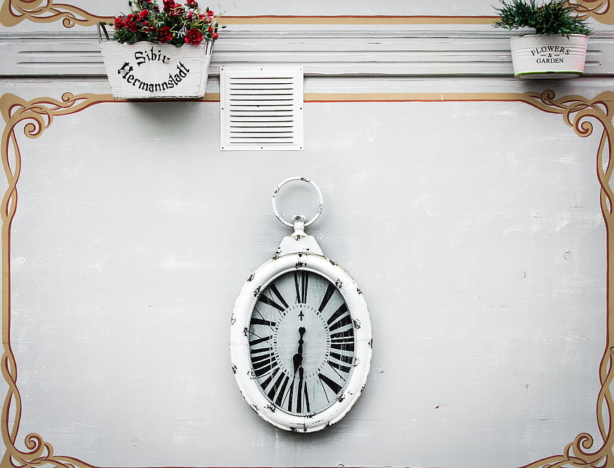 Vintage White Clock on Wall with Flower Pots