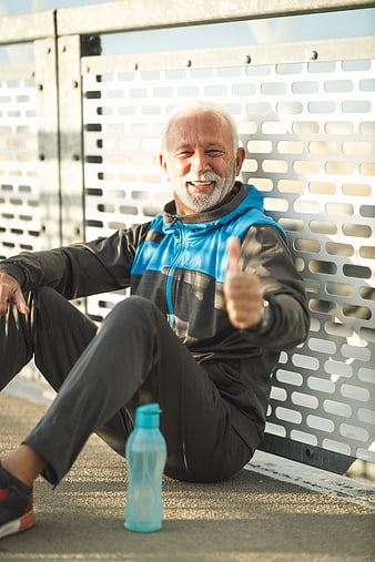 Happy Senior Man Resting After Workout Giving Thumbs Up
