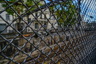 Chain link fence overlooking urban train tracks