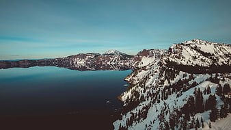Aerial View of Snow-Covered Mountains and Calm Lake