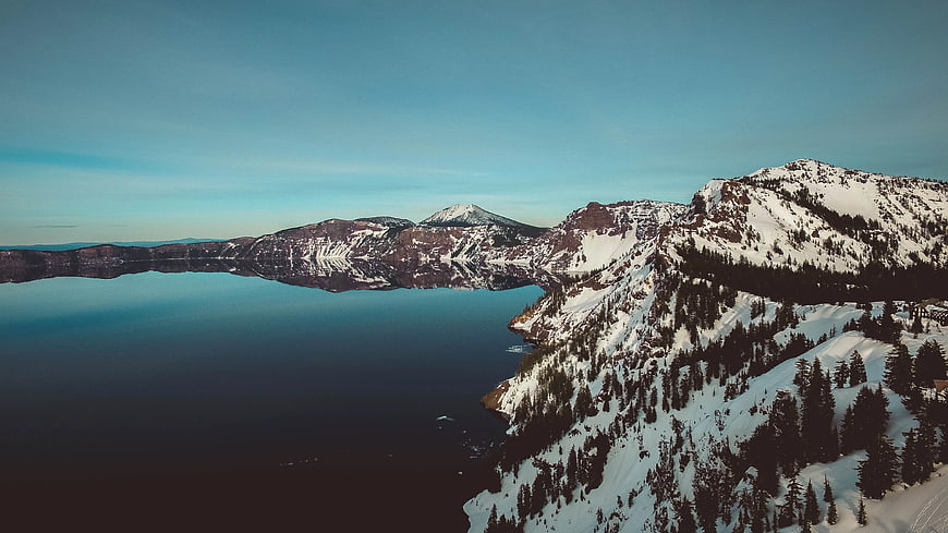 Aerial View of Snow-Covered Mountains and Calm Lake