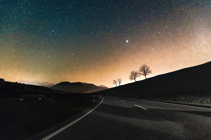 Milky Way Night Sky Over Mountain Road With Silhouetted Trees
