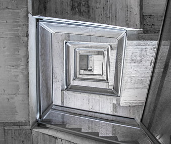 Abstract concrete stairwell with metal mesh railings