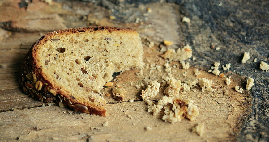 Sliced Whole Grain Bread with Seeds on Rustic Wood