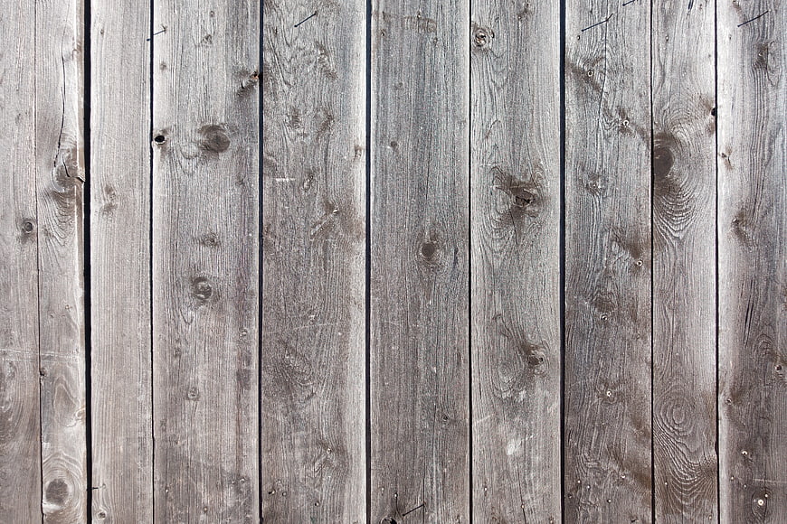 Weathered gray wooden fence planks background texture