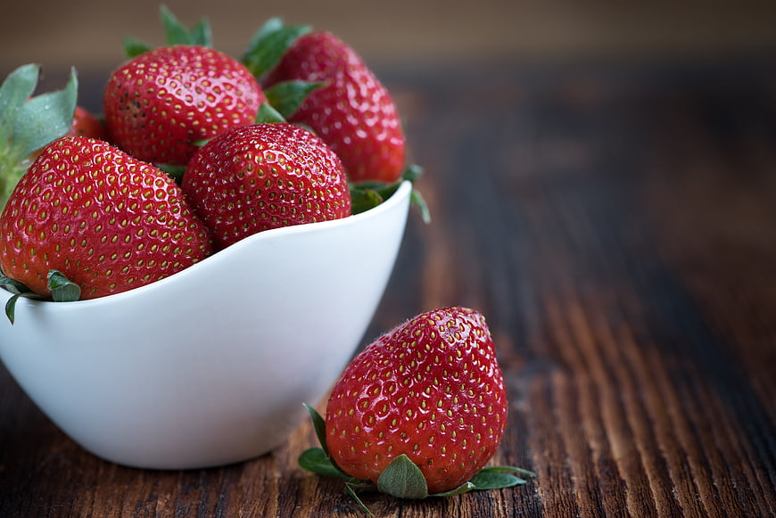 Fresh Red Strawberries in White Bowl on Wooden Table
