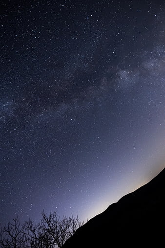 Starry Night Sky with Milky Way and Mountain Silhouette