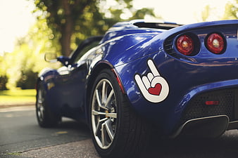 Rear view of blue sports car with heart hand sticker