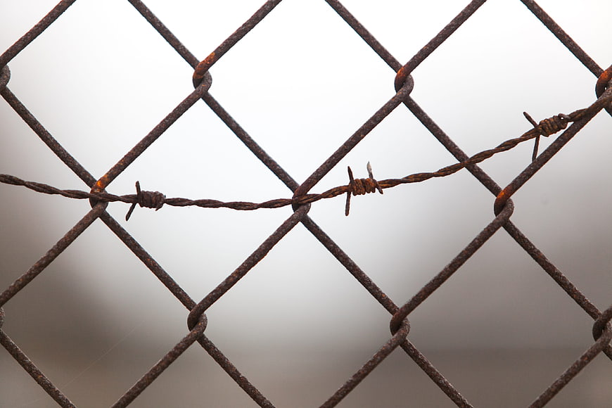 Rusty Chain Link Fence With Barbed Wire Close Up