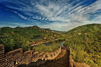 Great Wall of China overlooking a scenic mountain lake and green hills