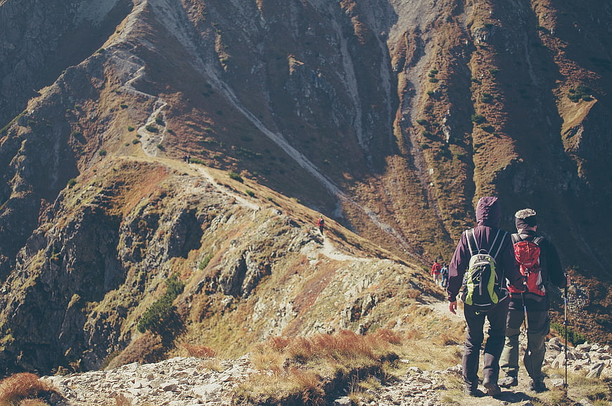 Hikers on Mountain Trail with Scenic Valley View