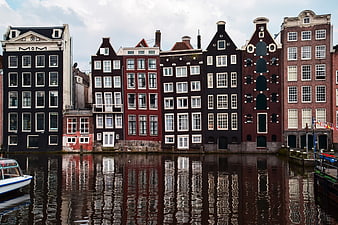 Historic Amsterdam Canal Houses With Reflections In Water
