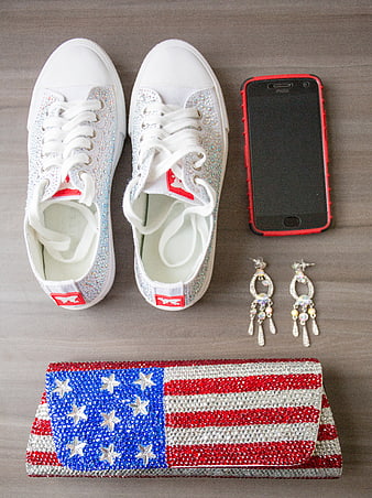 Patriotic fashion flat lay with rhinestone sneakers and flag clutch