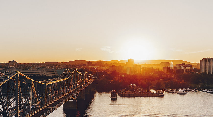 Golden Sunset Over Steel Bridge and River Cityscape