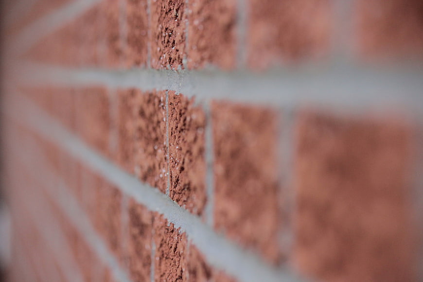 Close-up of red brick wall texture with shallow depth of field