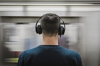 Man with Headphones on Subway Platform