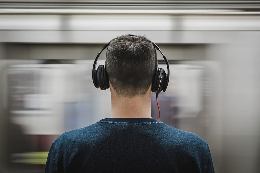 Man with Headphones on Subway Platform