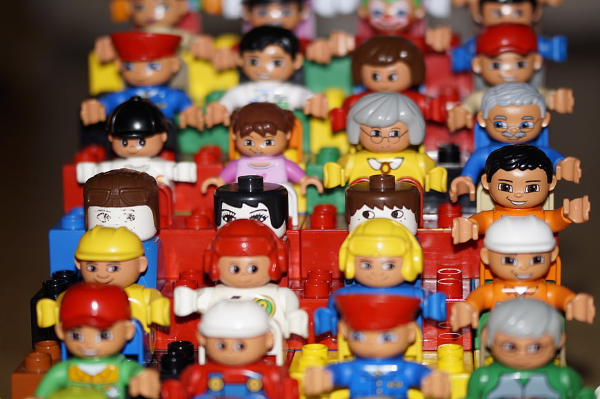 Colorful Lego Duplo figures sitting in a grandstand crowd