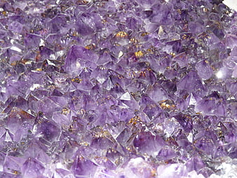 Close-up of raw purple amethyst crystal cluster with natural texture