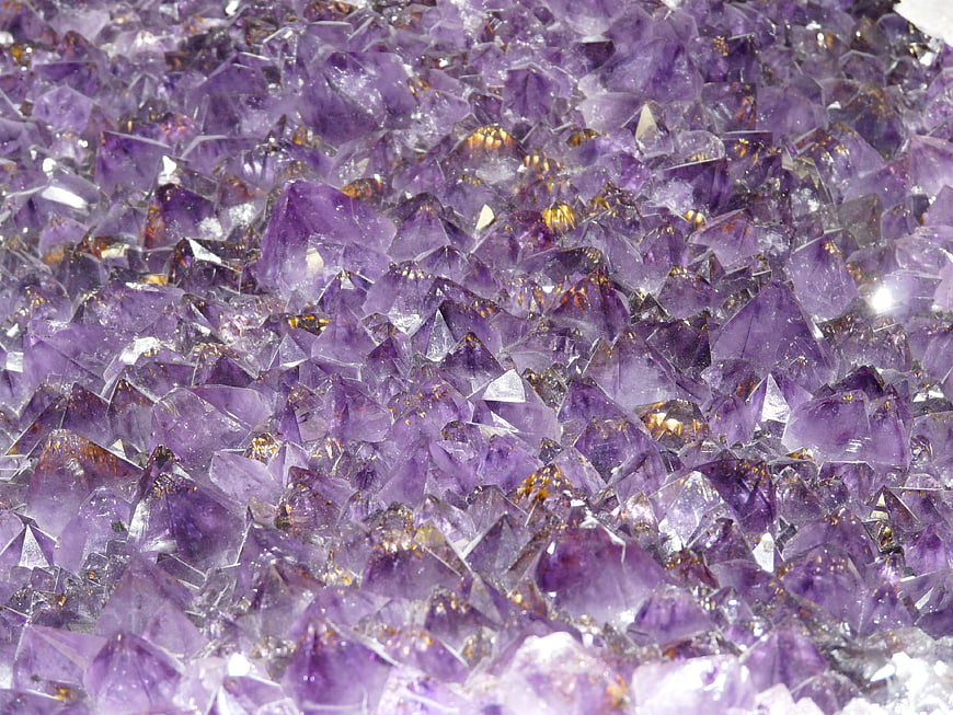 Close-up of raw purple amethyst crystal cluster with natural texture