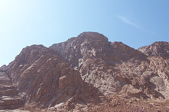 Rugged rocky mountain peak against clear blue sky
