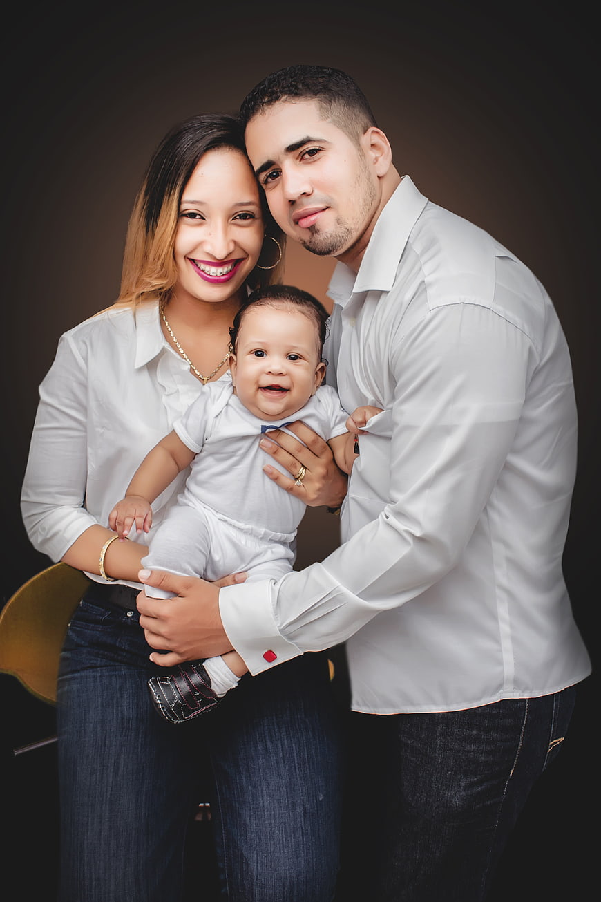 Happy Hispanic Family Portrait with Baby in Studio