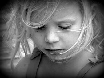 Black and white portrait of a young girl looking down