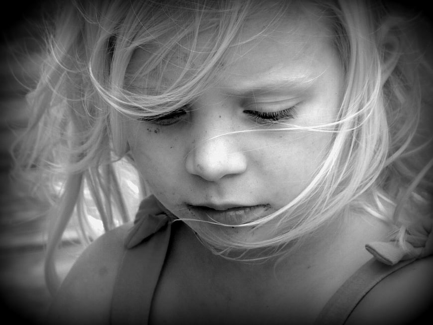 Black and white portrait of a young girl looking down