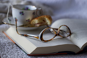 Cozy Reading Scene with Glasses, Book, and Tea Cup