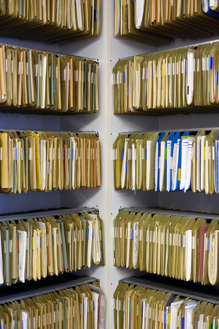 Organized office filing cabinet shelves with hanging manila folders